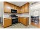 Cozy kitchen with updated appliances and a view to the dining area at 418 Whisper Wood Way, Locust Grove, GA 30248