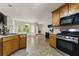 Open kitchen with stainless steel appliances and a bright breakfast nook at 418 Whisper Wood Way, Locust Grove, GA 30248