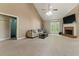 Expansive living area featuring neutral tones, vaulted ceiling, fireplace and access to the outdoors at 418 Whisper Wood Way, Locust Grove, GA 30248