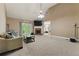 Spacious living room with high ceilings, fireplace, and French doors leading to the backyard at 418 Whisper Wood Way, Locust Grove, GA 30248
