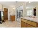 Bright main bathroom boasts double vanities and an open layout, seamlessly connecting to the bedroom and walk-in closet at 418 Whisper Wood Way, Locust Grove, GA 30248
