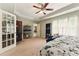 Serene bedroom featuring a tray ceiling, ample natural light, and a connected bathroom with walk-in closet at 418 Whisper Wood Way, Locust Grove, GA 30248