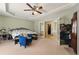 Spacious bedroom with tray ceiling, walk-in closet access, and a view into the connected main bathroom at 418 Whisper Wood Way, Locust Grove, GA 30248