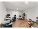 Finished basement area with hardwood floors, providing ample space for multiple computer setups and work areas at 418 Whisper Wood Way, Locust Grove, GA 30248