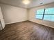Bright bedroom with wood-look flooring and a window at 3800 Travis Trce, Decatur, GA 30032