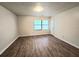 Bright bedroom with wood-look flooring and a window at 3800 Travis Trce, Decatur, GA 30032