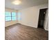 Bright bedroom with wood-look flooring and a window at 3800 Travis Trce, Decatur, GA 30032