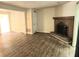 Spacious living room with a brick fireplace and wood-look flooring at 3800 Travis Trce, Decatur, GA 30032