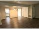 Open-concept living space with wood-look floors flowing into the kitchen and dining area at 3800 Travis Trce, Decatur, GA 30032
