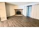 Spacious living room with a brick fireplace and wood-look flooring at 3800 Travis Trce, Decatur, GA 30032