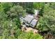 An aerial view of a home nestled in a lush green landscape and mature trees at 466 Victoria Rd, Woodstock, GA 30189