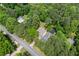 Aerial view of a charming home with detached garage nestled among mature trees and beautiful landscaping at 466 Victoria Rd, Woodstock, GA 30189