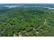 A wide aerial view of a forest, roads, and a glimpse of Lake Hartwell in the distance at 466 Victoria Rd, Woodstock, GA 30189