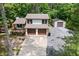 Aerial view of charming home, with detached garage, mature trees, and inviting front porch at 466 Victoria Rd, Woodstock, GA 30189
