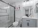 Bathroom features glass enclosed shower, toilet, vanity, and modern finishes at 466 Victoria Rd, Woodstock, GA 30189