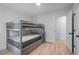 Bright bedroom features natural light, hardwood floors, and bunk bed at 466 Victoria Rd, Woodstock, GA 30189