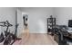 Bright bedroom featuring an exercise bike, light wood floors, and open doorway at 466 Victoria Rd, Woodstock, GA 30189