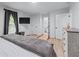 Bedroom with gray bedding, hardwood floors, a TV, and an attached bathroom at 466 Victoria Rd, Woodstock, GA 30189