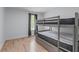 Bedroom features bright natural light, hardwood floors, and bunk bed at 466 Victoria Rd, Woodstock, GA 30189