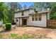 Rear exterior view of the home showcasing the backyard, patio, and well-maintained landscaping at 466 Victoria Rd, Woodstock, GA 30189