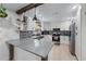Bright kitchen boasts stainless appliances, stone backsplash, granite counters, and ample storage space at 466 Victoria Rd, Woodstock, GA 30189