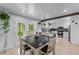 Bright eat-in kitchen features white cabinetry, stainless appliances, butcher block counters, and exterior access at 466 Victoria Rd, Woodstock, GA 30189