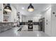 Modern kitchen features stainless appliances, open shelving, stone backsplash, and granite countertops at 466 Victoria Rd, Woodstock, GA 30189