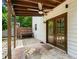 Covered patio with double glass doors and an outdoor bench offers a cozy retreat at 466 Victoria Rd, Woodstock, GA 30189