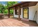 Charming covered porch with a decorative yellow door, offering a cozy and inviting entrance to the home at 466 Victoria Rd, Woodstock, GA 30189
