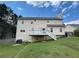 Back exterior of the house featuring a white wood deck and a large, grassy yard at 525 Dunagan Dr, Lawrenceville, GA 30045