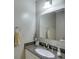 Bathroom with granite counters, modern fixtures, and white cabinets at 525 Dunagan Dr, Lawrenceville, GA 30045
