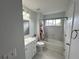 Bright bathroom featuring white cabinets, a single sink, and a tiled shower-tub combo at 525 Dunagan Dr, Lawrenceville, GA 30045