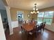 Formal dining room with hardwood floors, wainscoting, large window, and modern chandelier at 525 Dunagan Dr, Lawrenceville, GA 30045