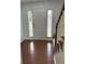 Open entryway features hardwood floors, staircase, sidelight windows, and a front door at 525 Dunagan Dr, Lawrenceville, GA 30045