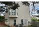 Tan home exterior with a bay window, two regular windows, and a locked steel door at 525 Dunagan Dr, Lawrenceville, GA 30045