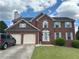 Beautiful brick home with a two-car garage, gray shutters, and a well-manicured front lawn at 525 Dunagan Dr, Lawrenceville, GA 30045