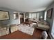 Cozy living room with hardwood floors, plush seating, and a large bay window for natural light at 525 Dunagan Dr, Lawrenceville, GA 30045