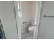 Powder room with toilet, grab bar, and window at 525 Dunagan Dr, Lawrenceville, GA 30045