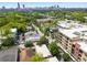 An aerial view shows a neighborhood with a skyline in the distance at 653 N Highland Ne Ave # 3, Atlanta, GA 30306