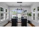 Elegant dining room with natural light from large windows, a glass table, and comfortable seating at 653 N Highland Ne Ave # 3, Atlanta, GA 30306