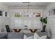 Dining area with a glass table, globe-style chandelier, and surrounded by natural light from large windows at 653 N Highland Ne Ave # 3, Atlanta, GA 30306