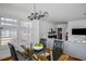 Bright dining room with a glass-top table, modern chandelier, and large windows with shutter blinds at 653 N Highland Ne Ave # 3, Atlanta, GA 30306