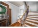 Entryway with hardwood floors, staircase with ornate railing, and decorative wreath on door at 653 N Highland Ne Ave # 3, Atlanta, GA 30306
