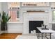 Living room featuring a fireplace, large windows, and stylish decor at 653 N Highland Ne Ave # 3, Atlanta, GA 30306
