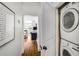 Hallway featuring hardwood floors and stacked washer and dryer at 653 N Highland Ne Ave # 3, Atlanta, GA 30306