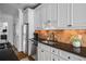 Bright kitchen with white cabinets, black granite countertops, and stainless steel appliances at 653 N Highland Ne Ave # 3, Atlanta, GA 30306