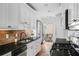 Kitchen with white cabinetry, granite countertops, stainless appliances, and access to a balcony at 653 N Highland Ne Ave # 3, Atlanta, GA 30306