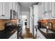 Well-lit kitchen features white cabinets, stainless steel appliances, and black granite countertops at 653 N Highland Ne Ave # 3, Atlanta, GA 30306