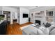 Open living room with hardwood floors, a stylish fireplace, and a comfortable gray sectional sofa at 653 N Highland Ne Ave # 3, Atlanta, GA 30306