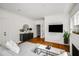 Cozy living room featuring hardwood floors, a modern fireplace, and a sleek TV mounted above at 653 N Highland Ne Ave # 3, Atlanta, GA 30306